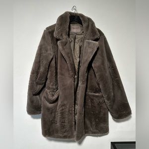 Taupe Blank faux fur coat. Single hook clasp with front pockets.